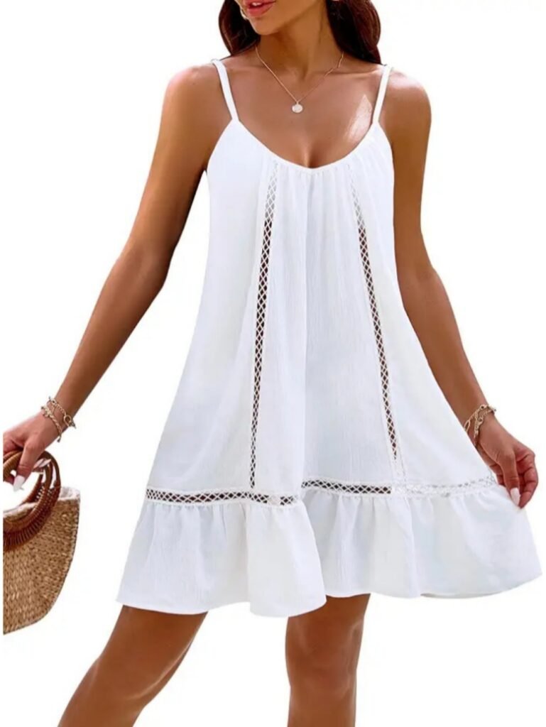White sleeveless ruffled dress with lace-up side panels and thin straps, worn with woven bag.