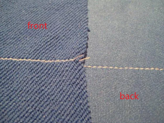 Blue textured swimwear fabric sample showing front (woven texture) and back (smooth knit) with white stitching, highlighting material differences for swimwear production.