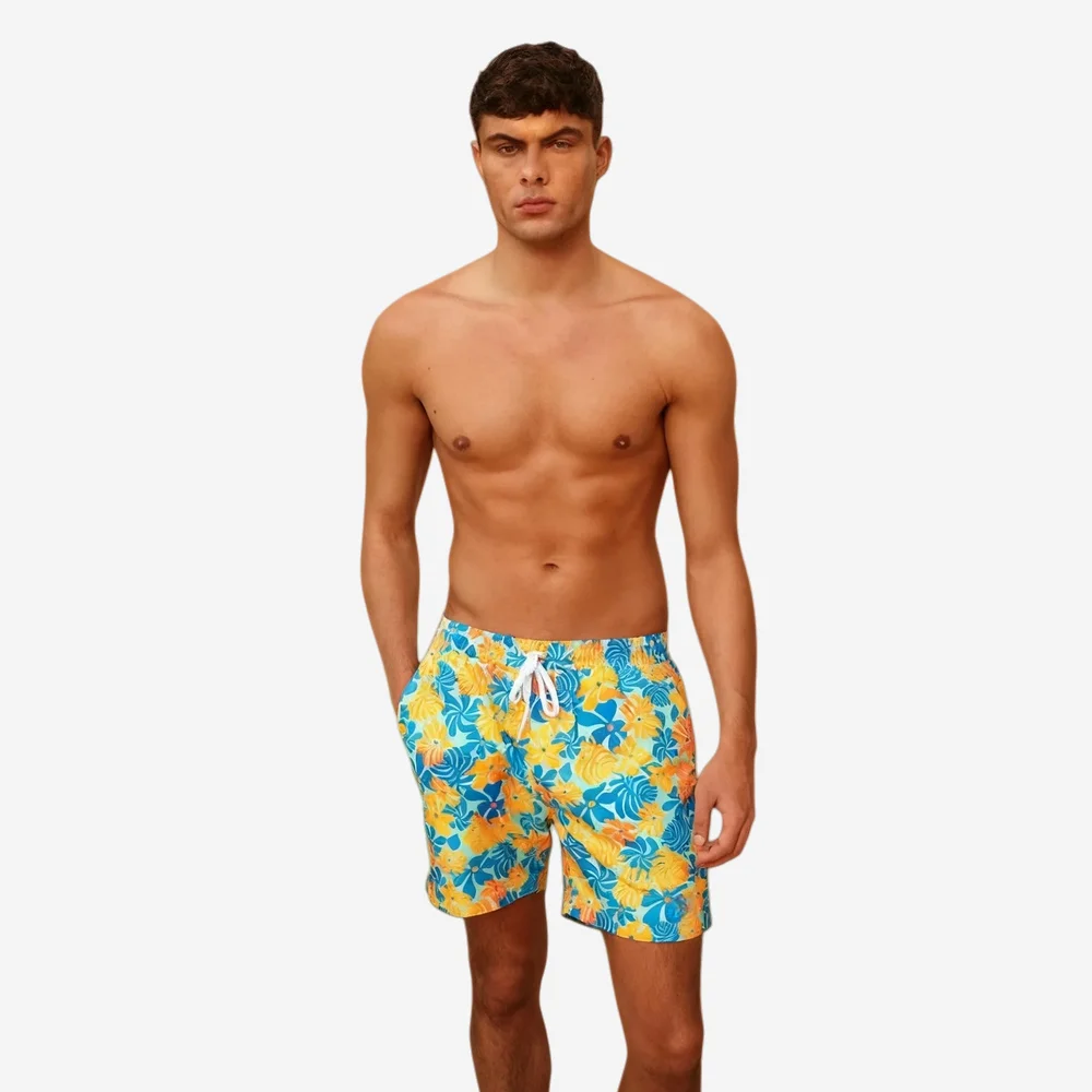 Men’s vibrant blue and yellow floral print swim trunks with white drawstring, showcasing summer-ready swimwear design.