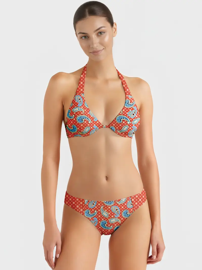 Red halter bikini top and matching bottoms with blue paisley pattern, high-cut waistband, stretch fabric for swimwear manufacturer collection.