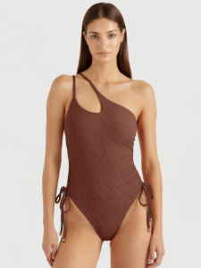 Brown ribbed one-shoulder swimsuit with side tie details and gold-toned hardware, showcasing high-quality swimwear design.