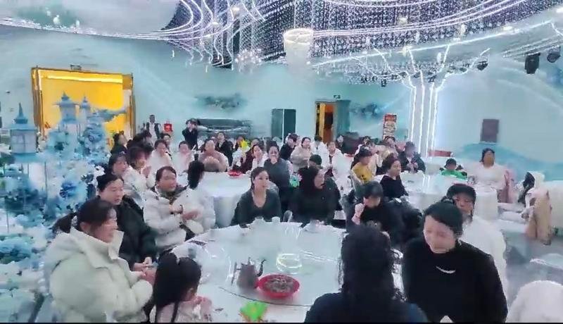 Female employees at Hongxiu Clothing celebrating International Women's Day with gifts and smiles