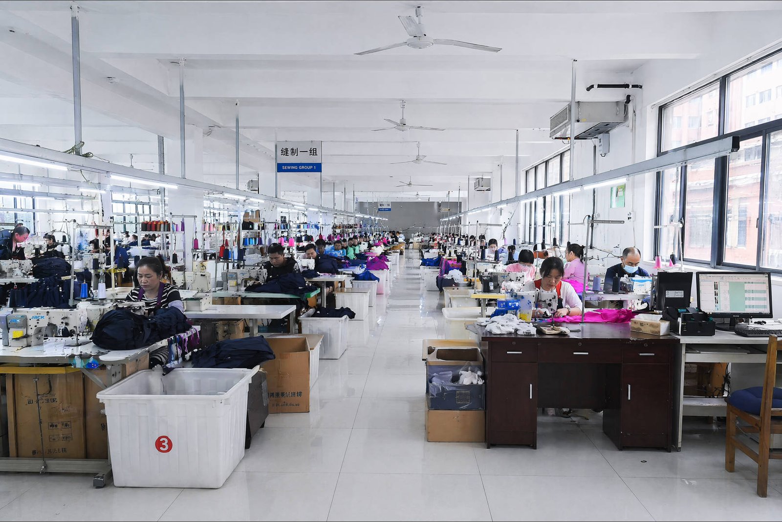 Workers sewing swimwear in the production line