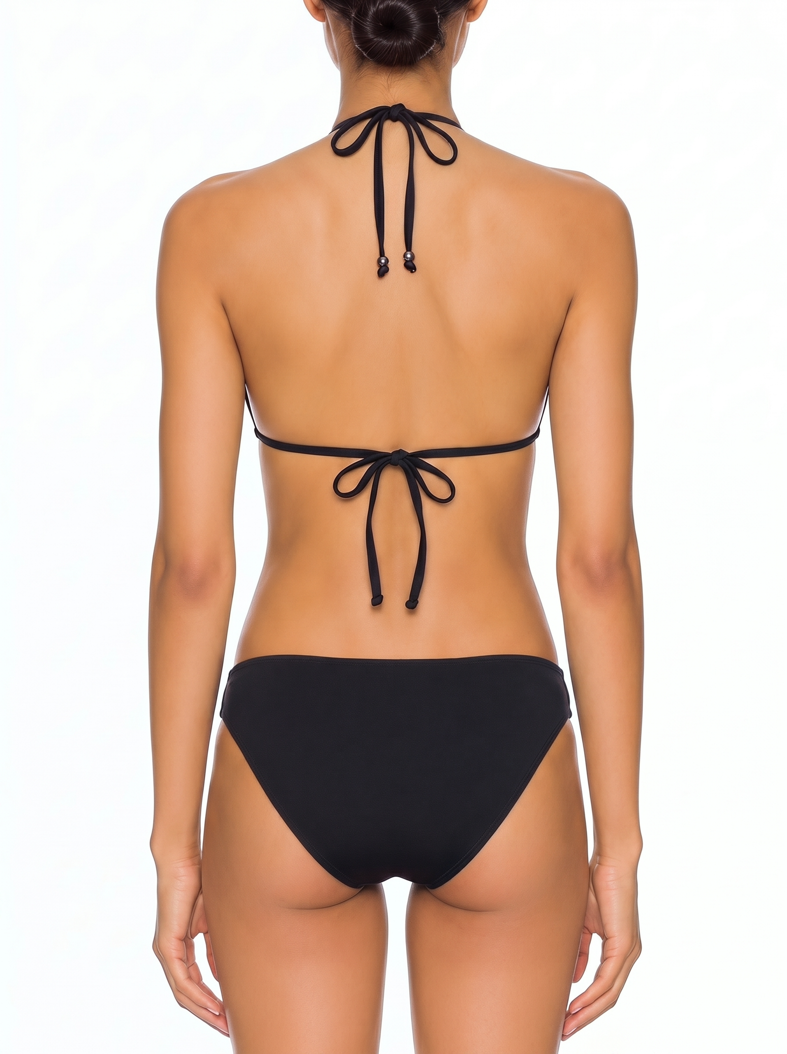 Back view of a woman wearing a black halter triangle bikini with tie closures and beaded ends.