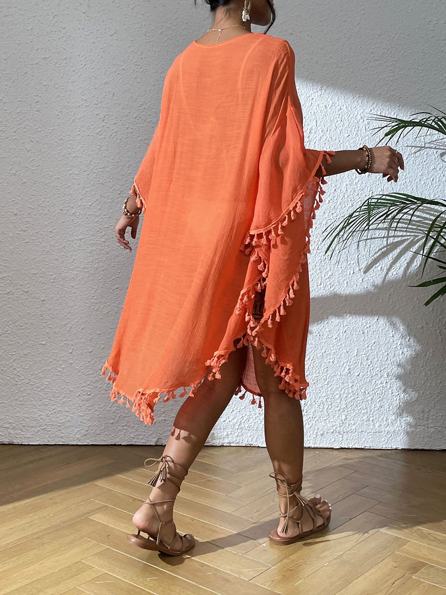 Orange loose-fitting kaftan cover-up with wide sleeves and decorative tassel trim along the hem and cuffs.