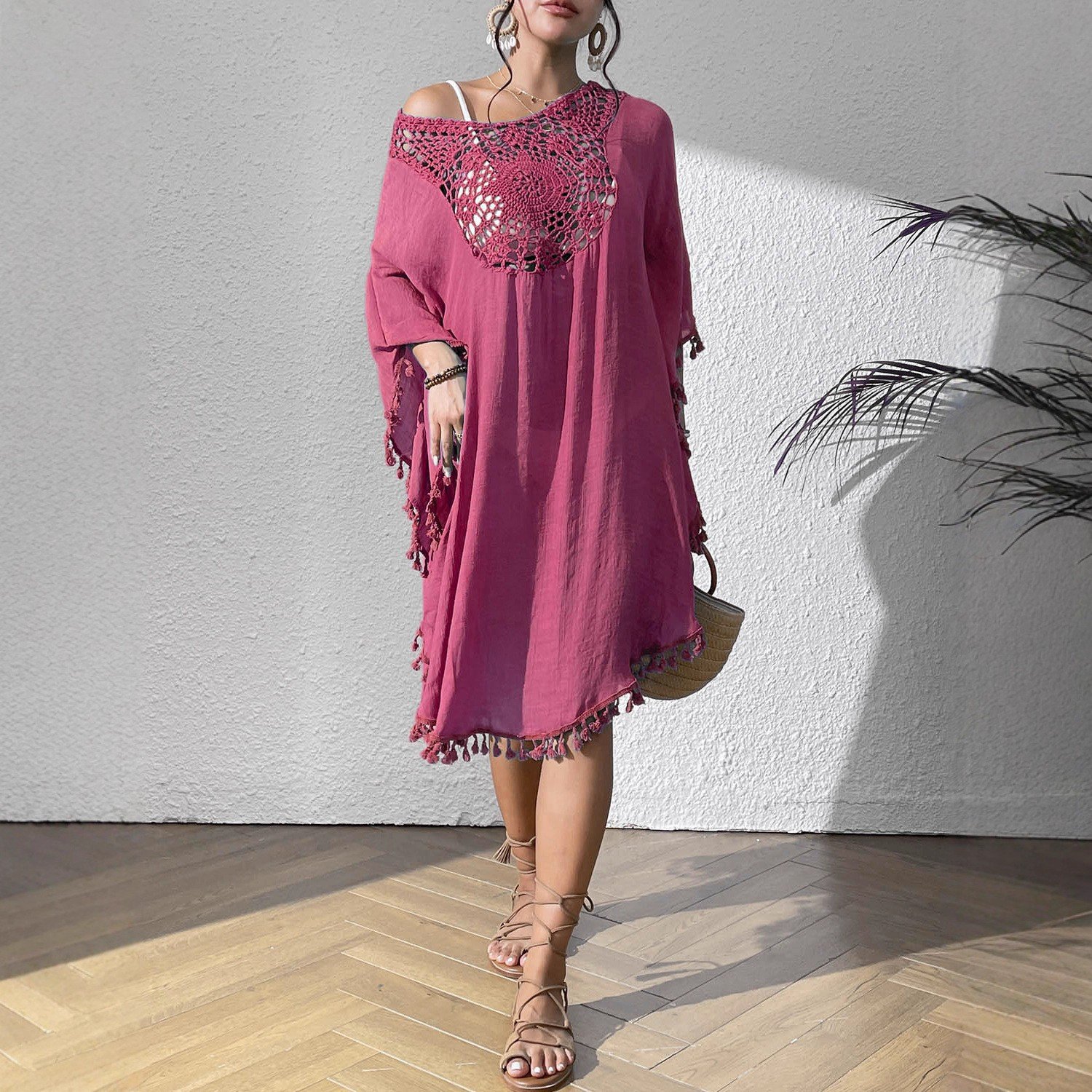 Pink loose-fitting kaftan cover-up featuring a crochet yoke neckline and decorative tassel trim on sleeves and hem.