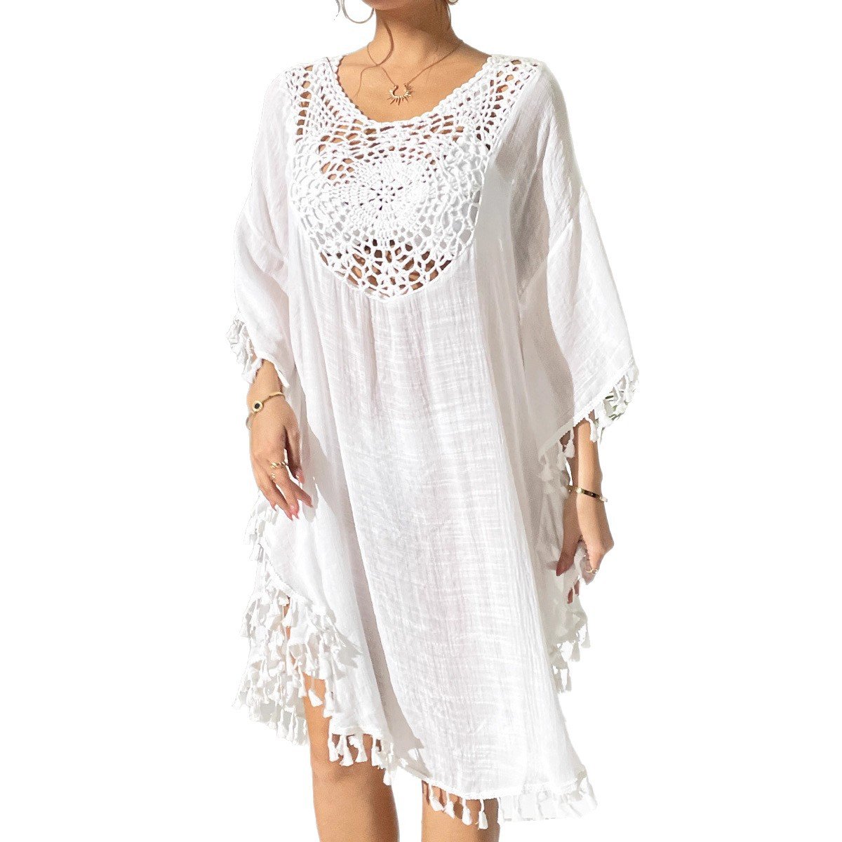 White loose-fitting kaftan cover-up with crochet yoke neckline and tassel trim on sleeves and hem.