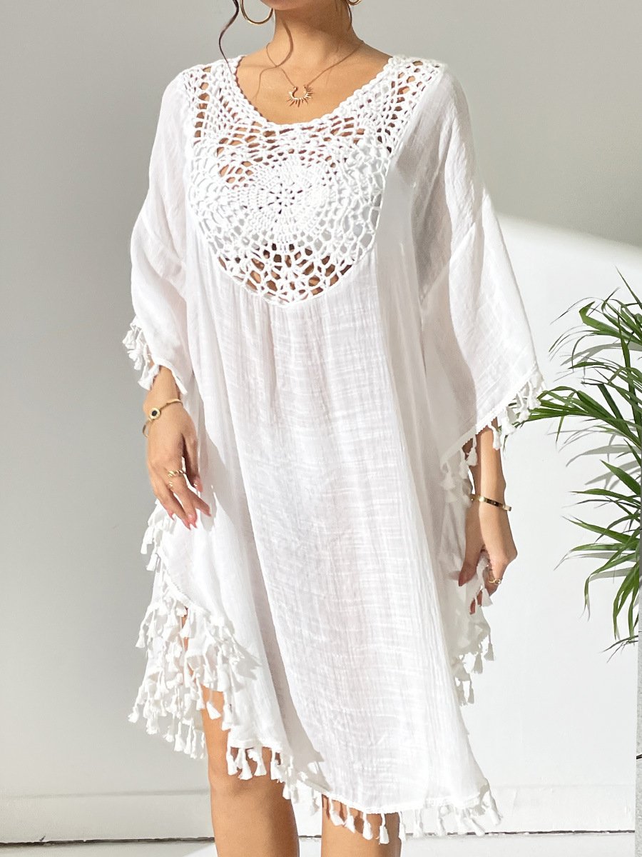 White loose-fitting kaftan cover-up featuring a crochet yoke neckline and tassel trim along the hem and sleeves.