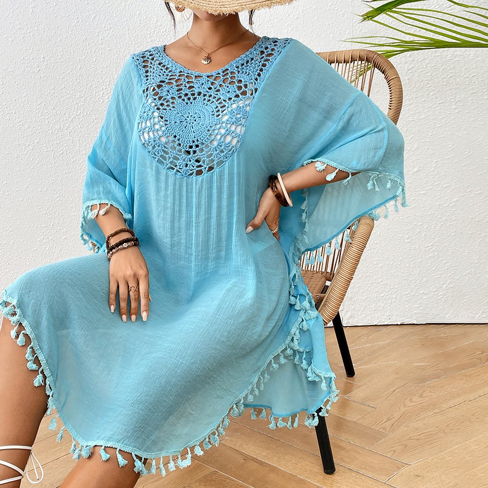 Blue loose-fitting kaftan cover-up with a crochet yoke panel and tassel trim on the sleeves and hem.