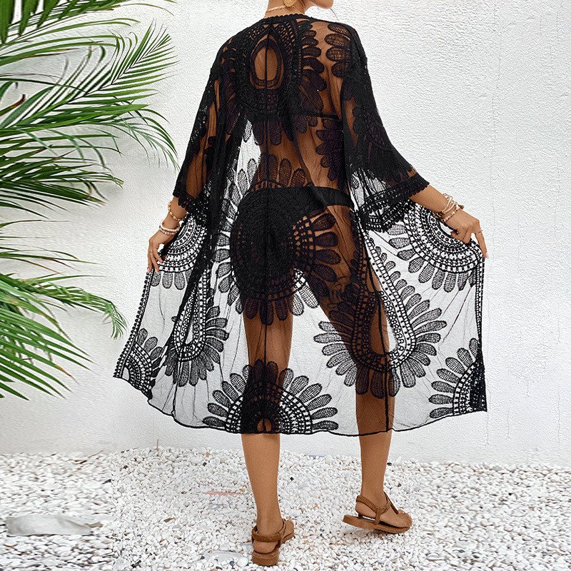 Black sheer open-front kaftan cover-up with floral cutout design, three-quarter bell sleeves, and scalloped hem.