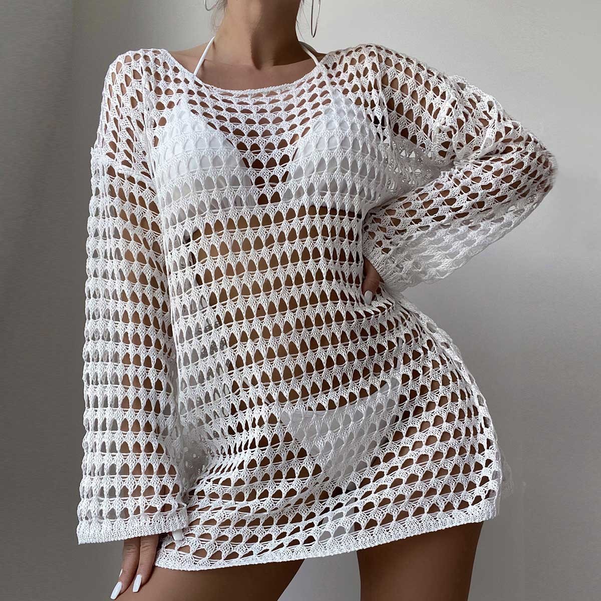 White long sleeve open-knit cover-up dress with boat neckline and mini length silhouette.