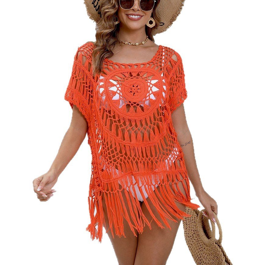 Orange open-knit fringe tunic cover-up with short sleeves, square neckline, and circular chest pattern.