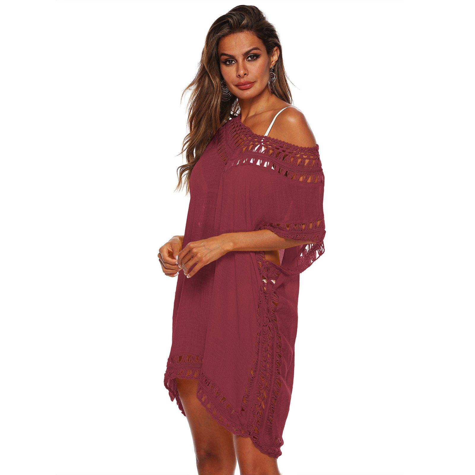 Woman wearing a mauve open-knit trim caftan cover-up with a deep V-neck and side slits.