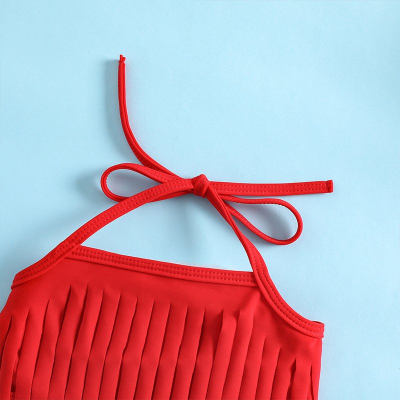 Close-up of a red girls' halter bikini top featuring a tie neck strap and fringe hem detail.