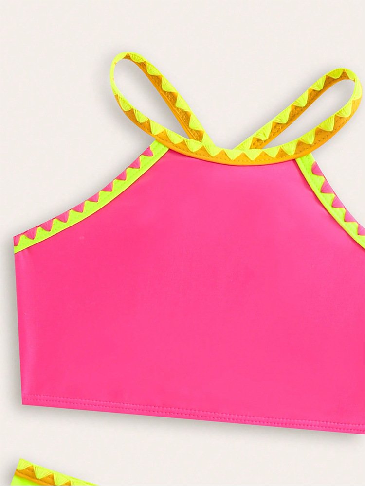 Pink girls' halter crop top with yellow crisscross straps and scalloped trim.