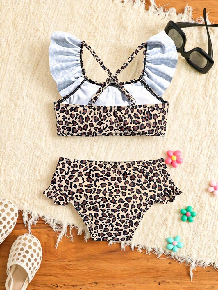 Girls' leopard print two-piece swimsuit featuring a ruffled crop top with crisscross straps and high-waisted bottoms.
