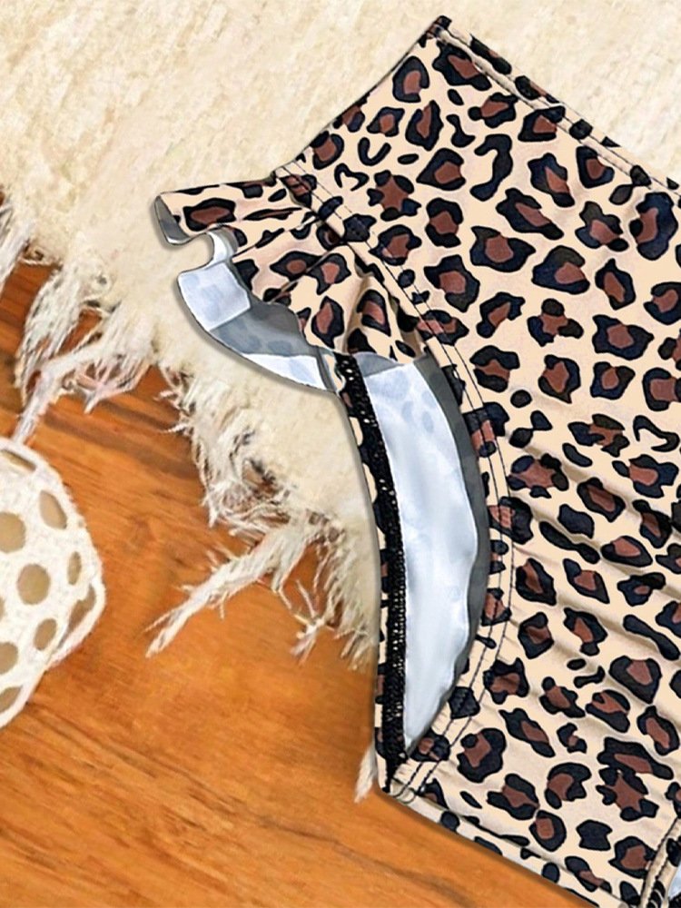 Close-up of leopard print high-waisted bikini bottoms with ruffled hem and black trim.