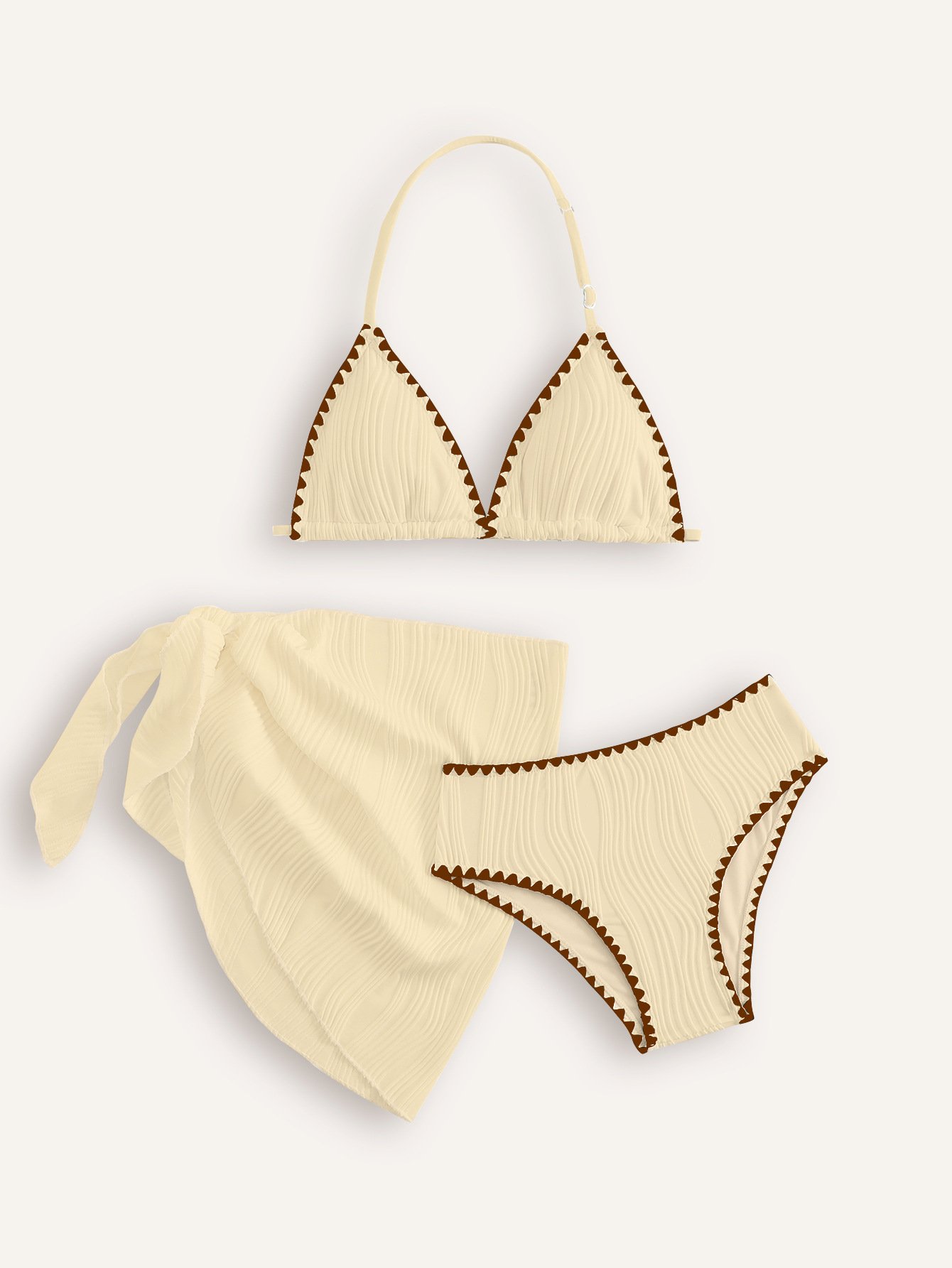 Cream girls' three-piece bikini set with halter triangle top, bottoms, and wrap skirt featuring brown trim.