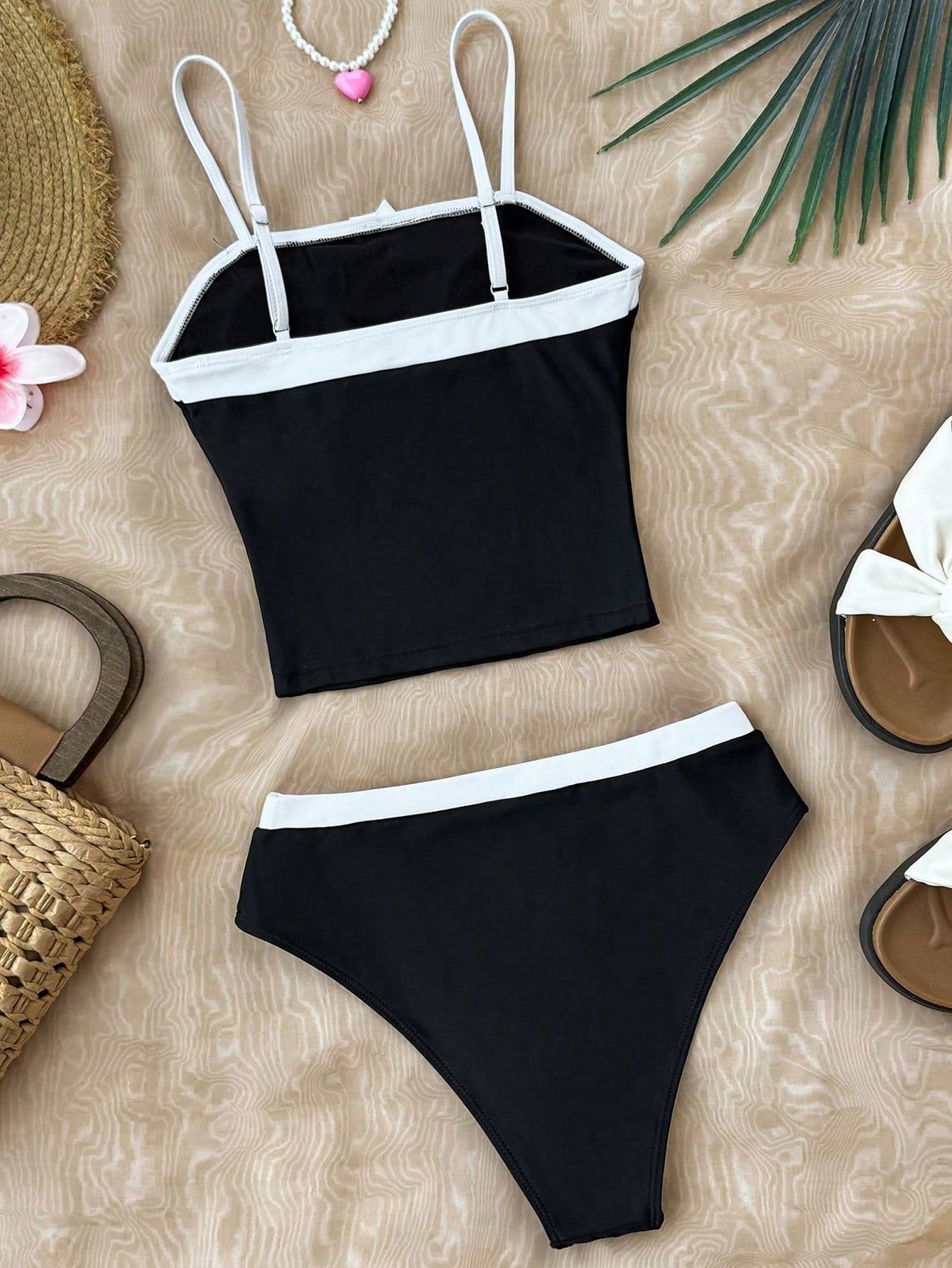 Black and white colorblock girls' bikini set with adjustable spaghetti strap tankini top and matching bottoms.