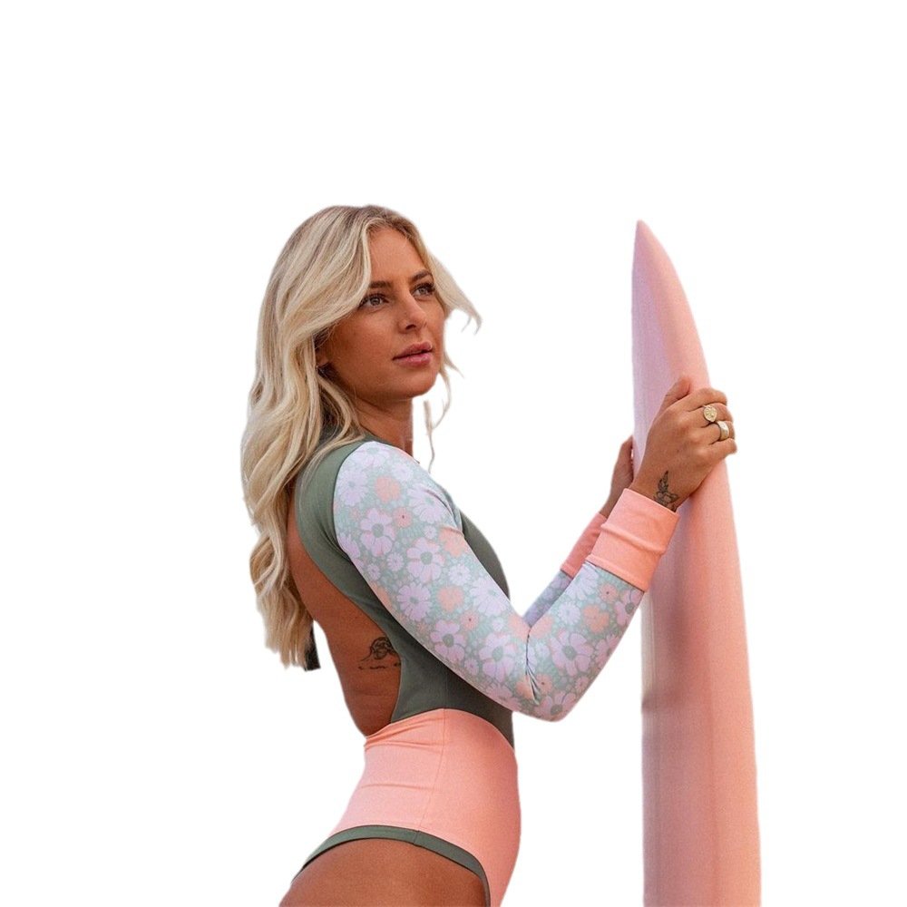 Model wearing a long-sleeve colorblock one-piece swimsuit featuring floral patterned sleeves, a high-cut leg, and an open back