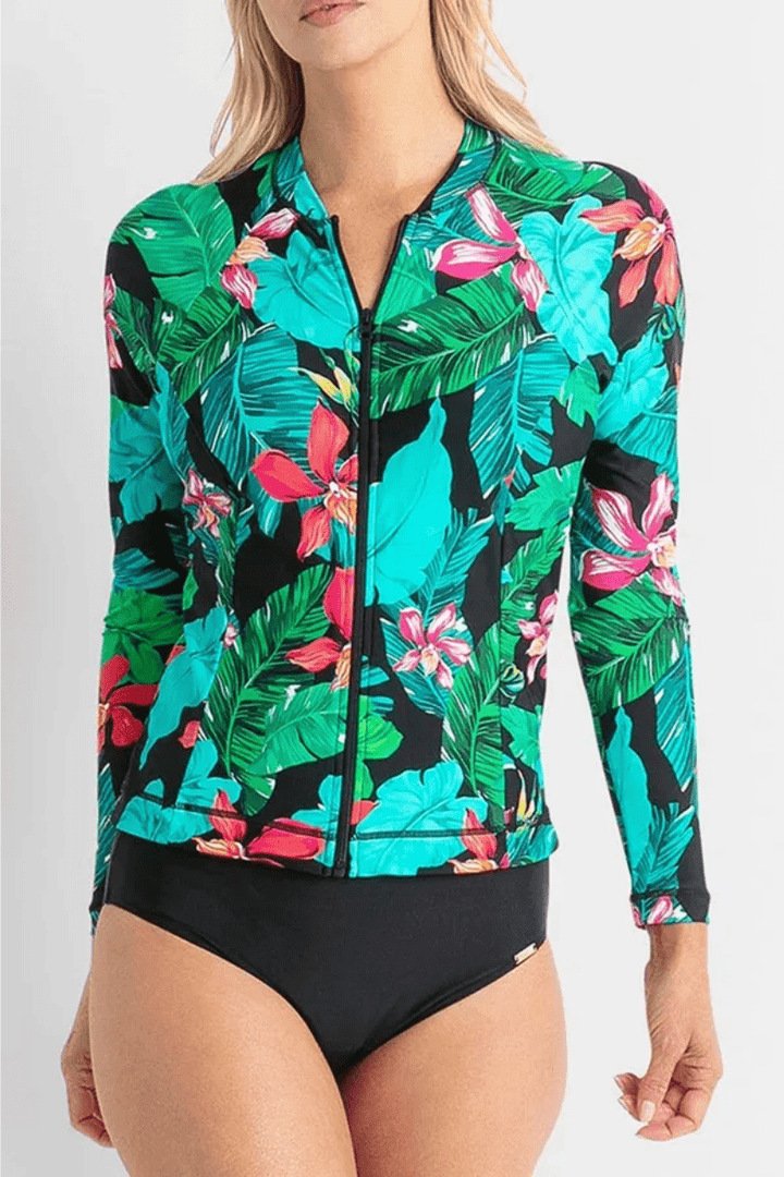 Women's long sleeve zip-up rash guard featuring a tropical leaf and floral print, paired with black bikini bottoms.