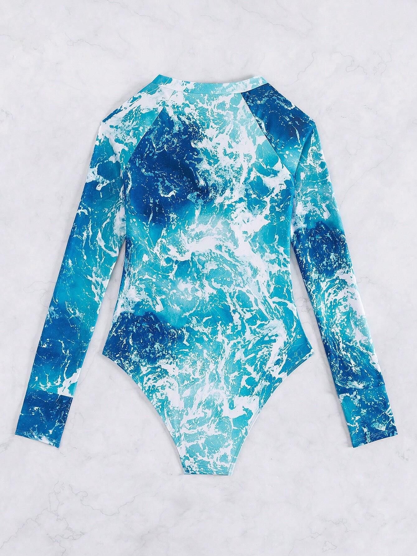Blue and white ocean print long sleeve one-piece rash guard with crew neck and high-cut legs.