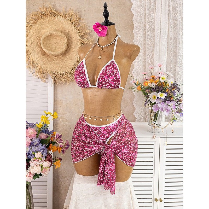 Pink and white floral print halter triangle bikini with a matching tie-wrap skirt bottom.