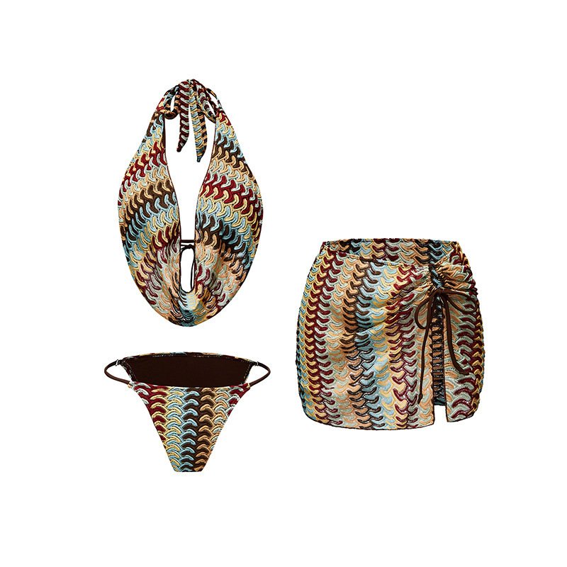 Patterned three-piece swimwear set featuring a halter plunge top, matching bottoms, and a high-waisted mini skirt.