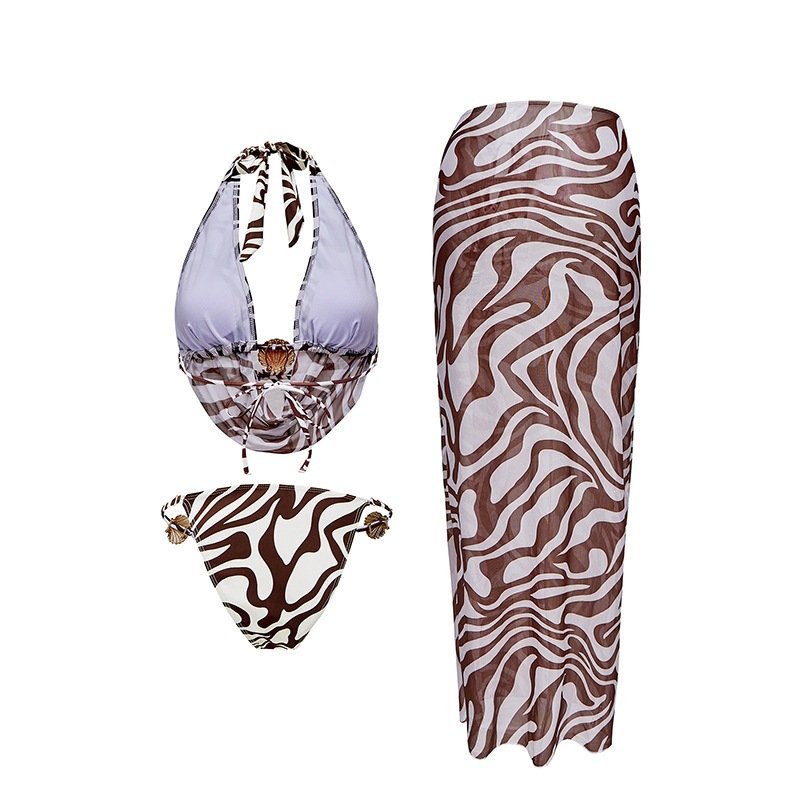Brown and white zebra print three-piece bikini set with halter top, side-tie bottoms, and maxi skirt.