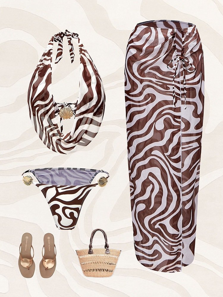 A three-piece zebra print swim set including a draped halter top, side-tie bottoms, and a high-waisted maxi skirt