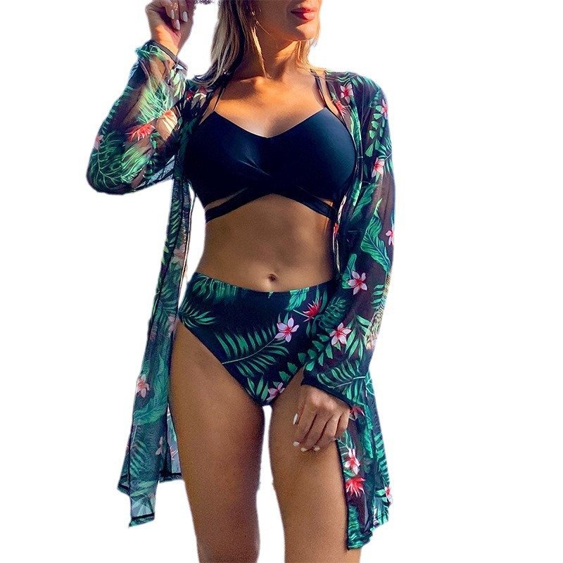 Women's three-piece swim set featuring a black strappy bikini top, floral high-waisted bottoms, and a sheer leaf-print long-sleeve