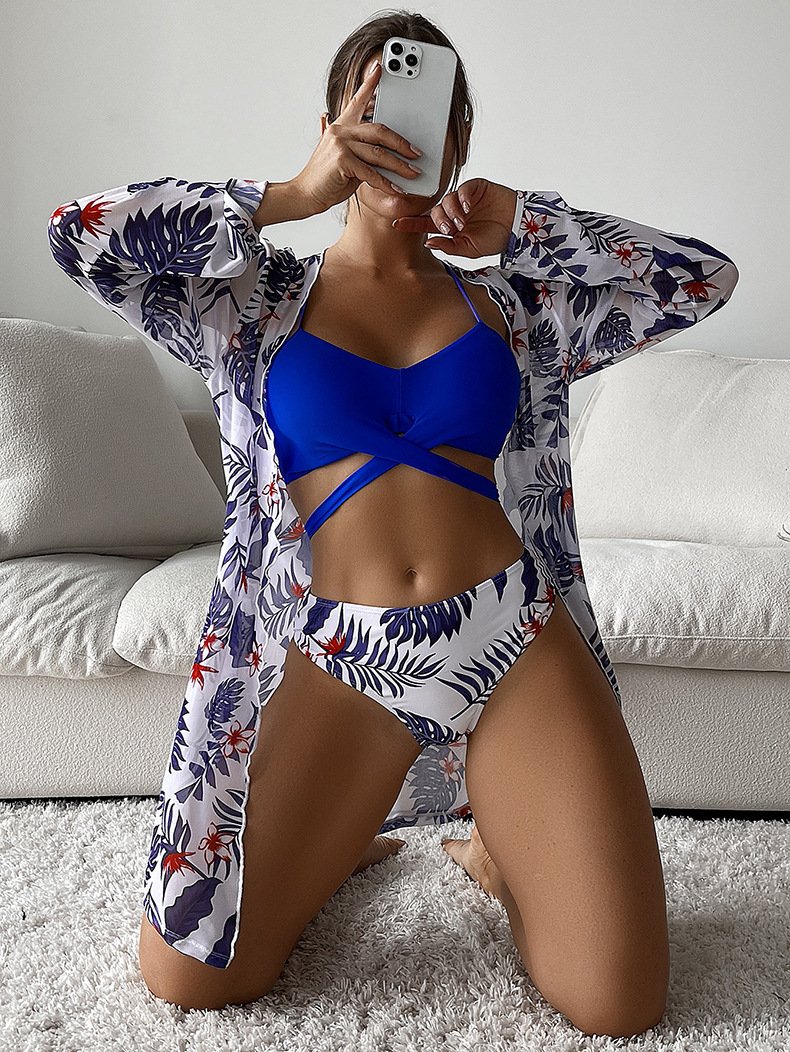 Blue bikini set with strappy underbust cutout and matching floral long-sleeve cover-up.