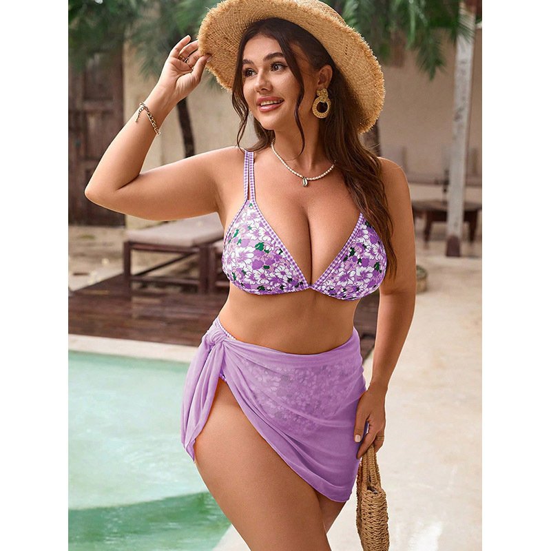 Purple floral triangle bikini top paired with a solid purple tie-side wrap skirt set.