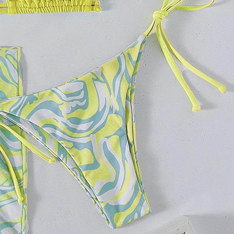 Yellow and blue swirl print tie-side bikini bottoms with matching wrap skirt.