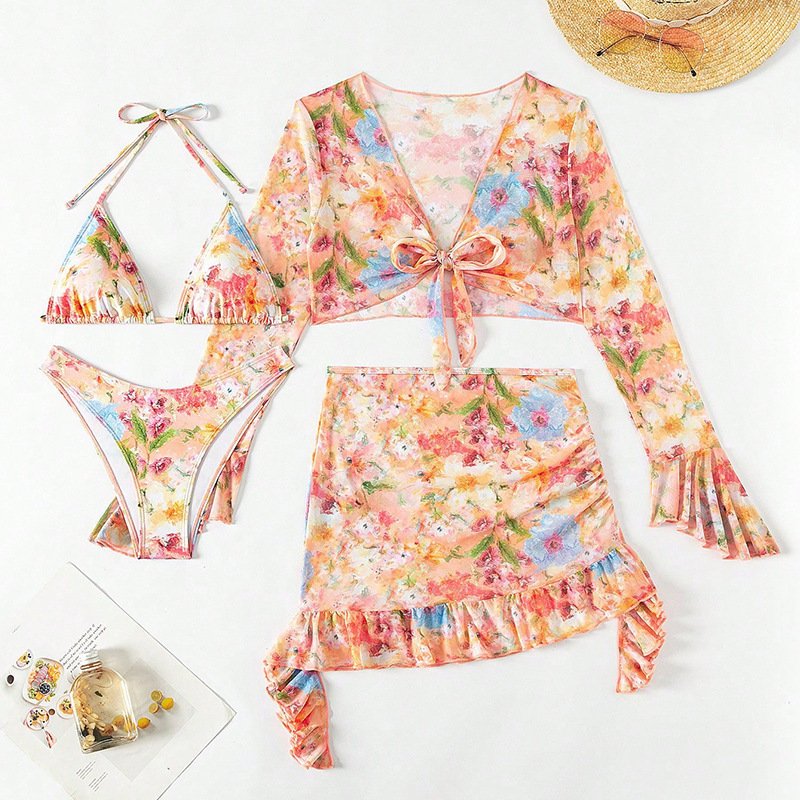 Floral print women's swimwear set featuring a triangle bikini, long-sleeve tie-front crop top, and ruffle wrap mini skirt