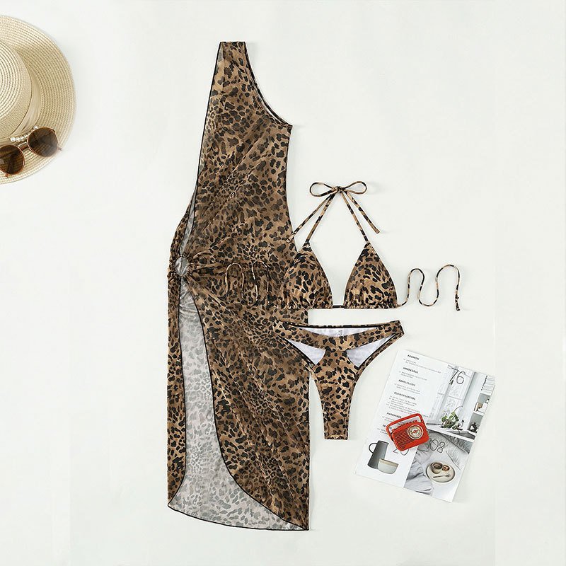 Leopard print three-piece swimwear set featuring a triangle bikini and a one-shoulder high-slit cover-up dress.