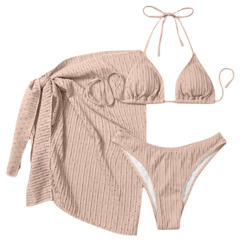 Beige crinkled three-piece swimwear set with triangle halter top, high-cut bottoms, and long-sleeve wrap skirt.