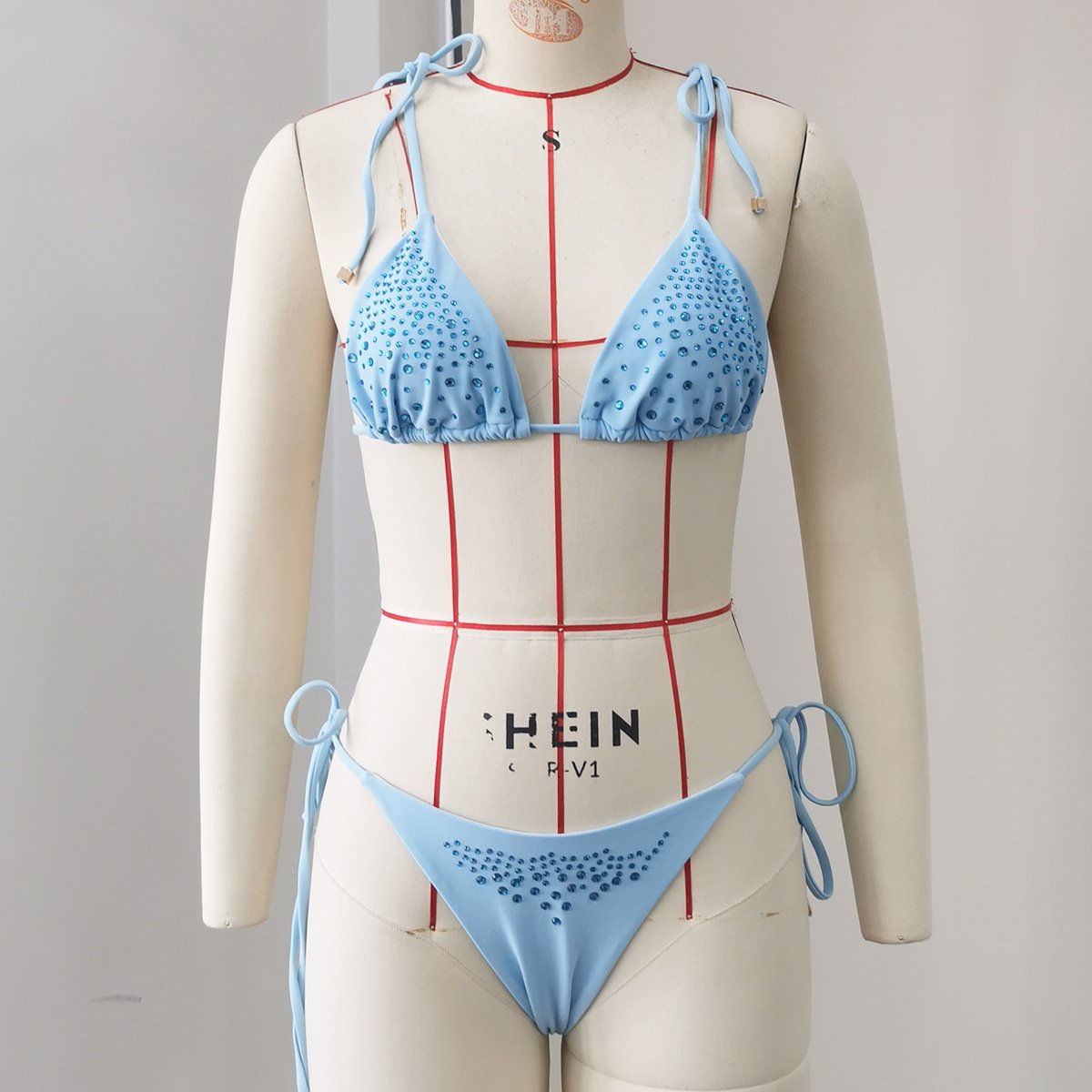 Light blue rhinestone triangle bikini set with tie-neck top and side-tie bottoms.