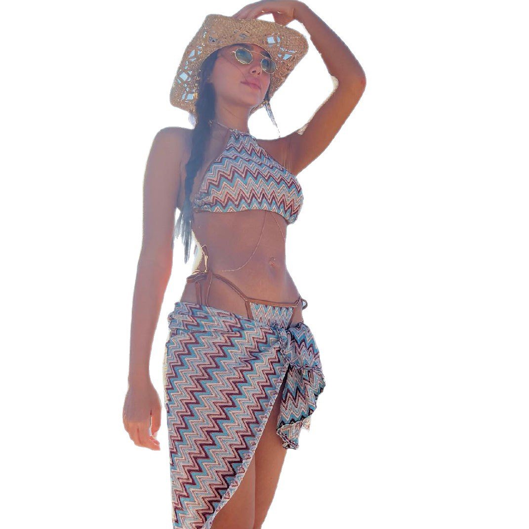 Model wearing a zigzag print halter bikini top and matching wrap skirt.