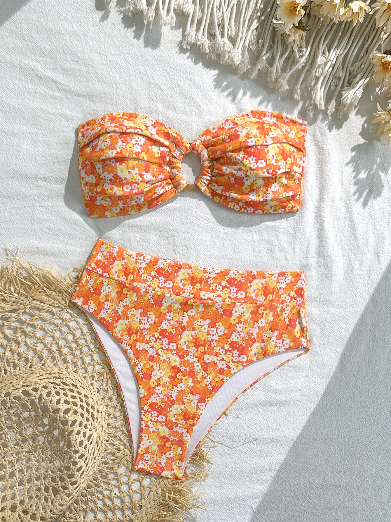 Orange floral print two-piece bikini set with a strapless bandeau top featuring a center ring accent and high-waisted