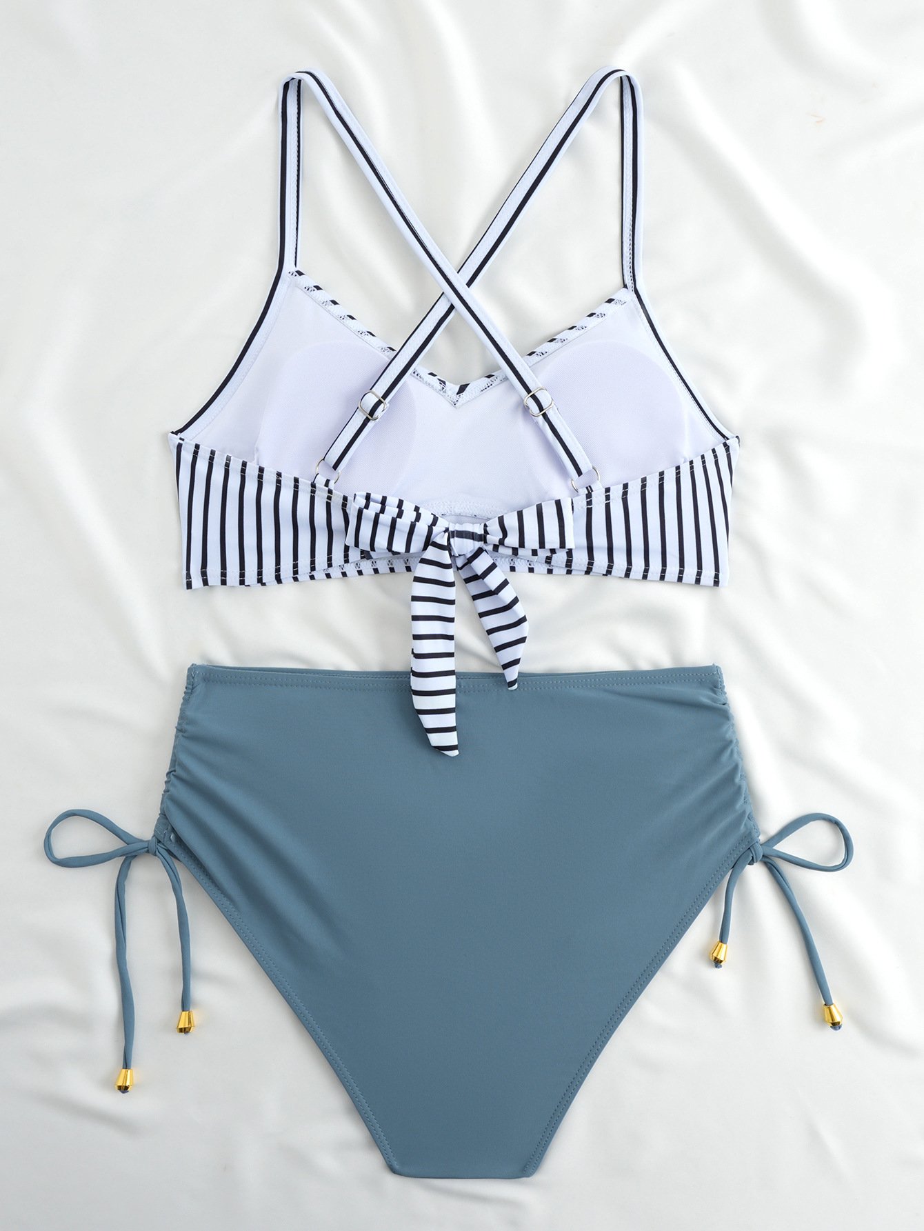 A two-piece bikini set featuring a striped halter crop top with a front tie and solid high-waist side-tie