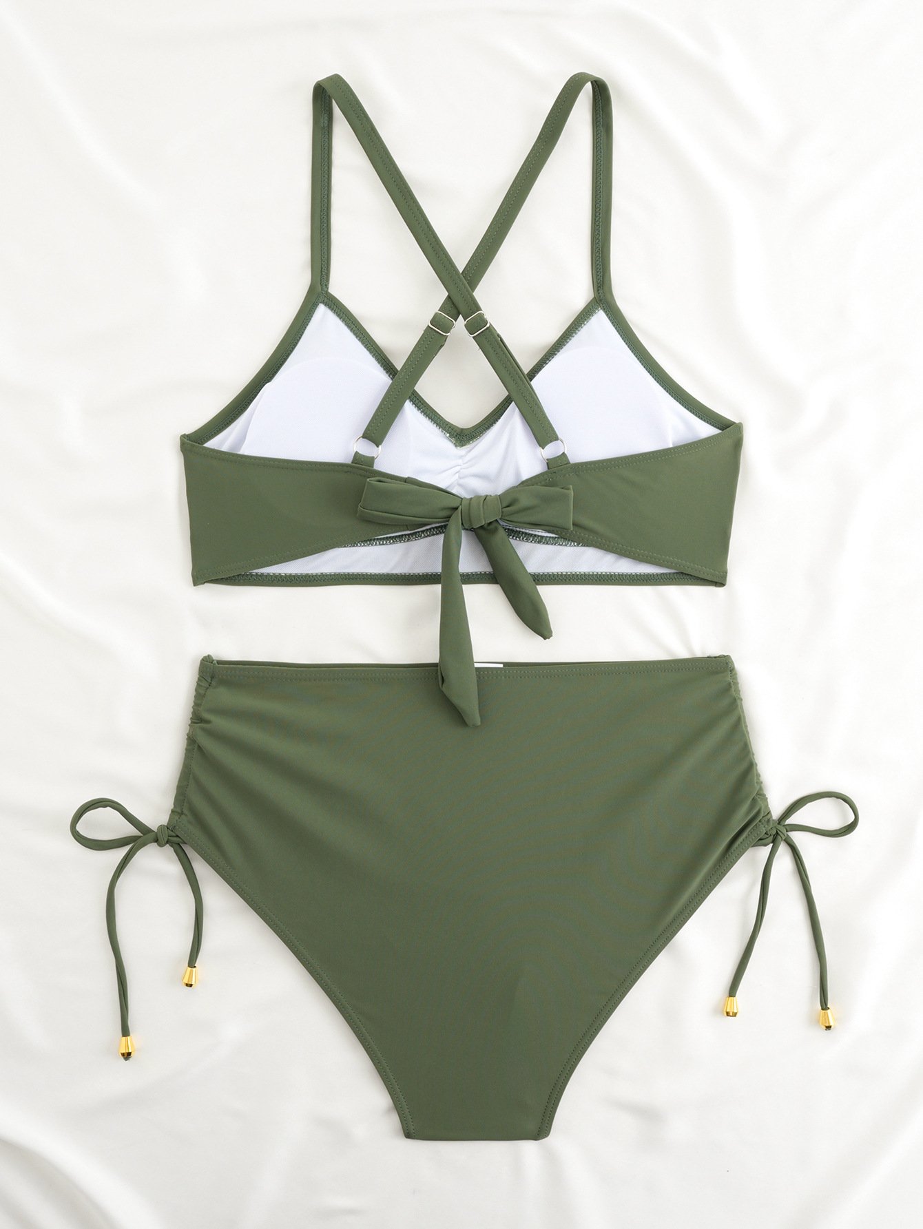 Green two-piece bikini set featuring a halter crop top with crossback straps, front bow, and high-waist tie-side bottoms.