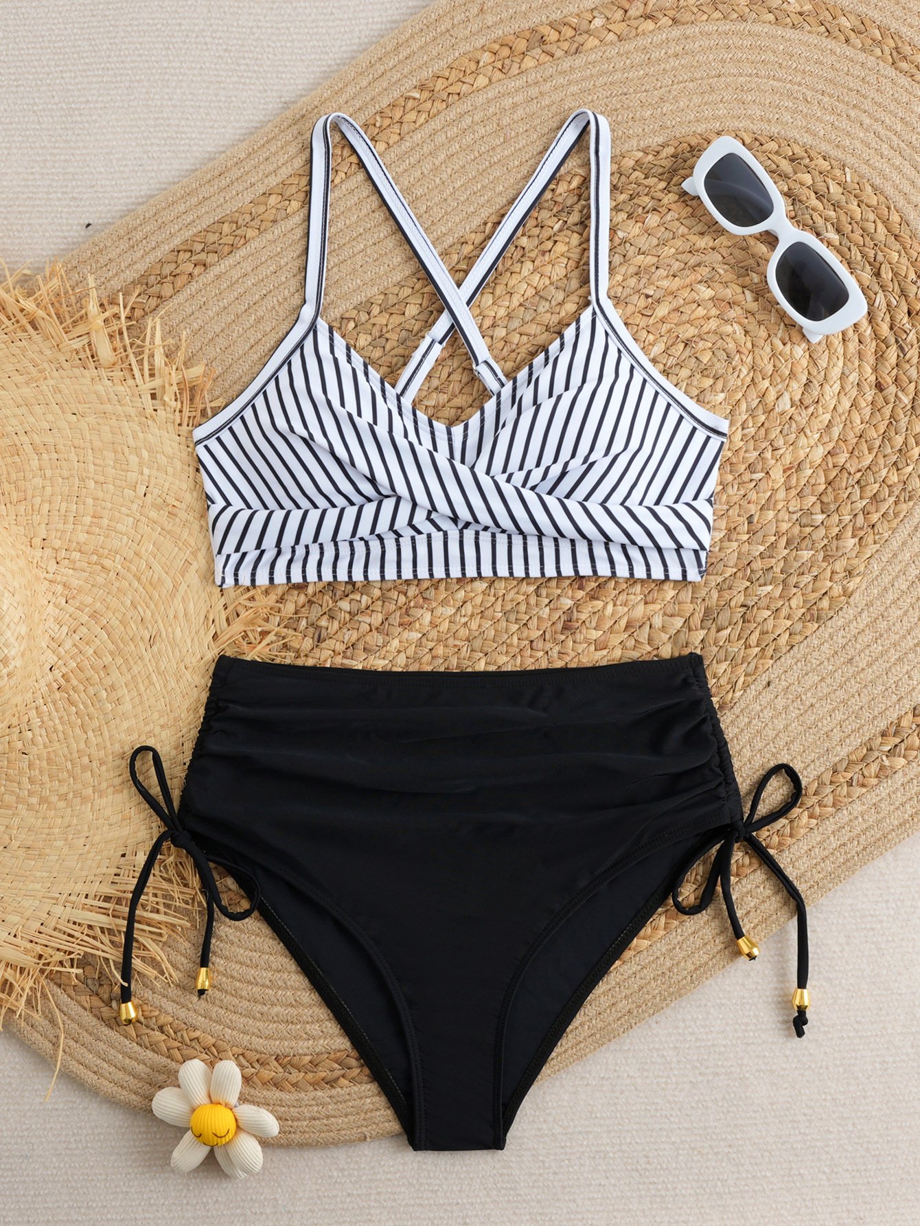 Black and white striped halter crop top bikini with solid black high-waist tie-side bottoms.