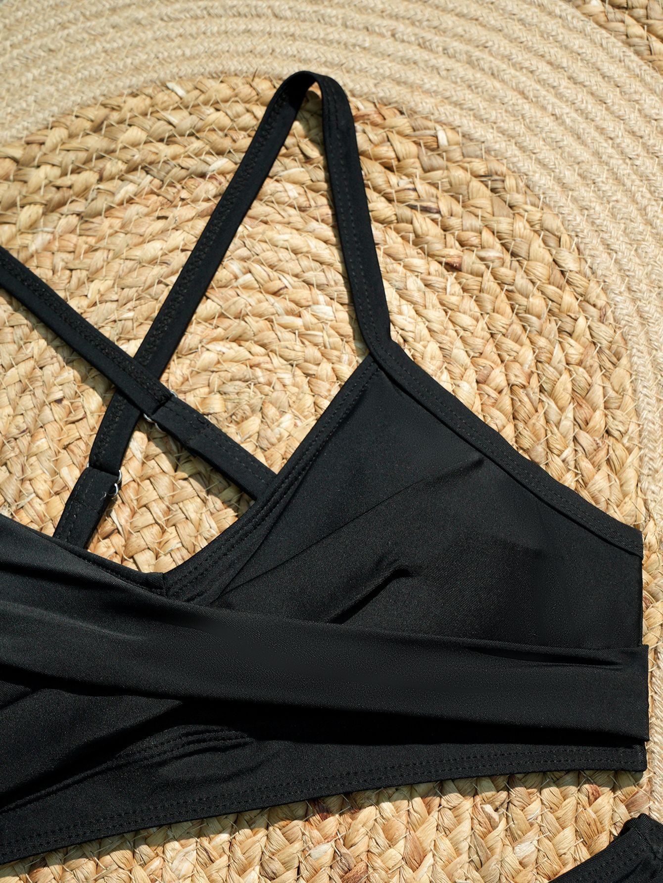 Black halter crop top with adjustable crossback straps and front ruching.