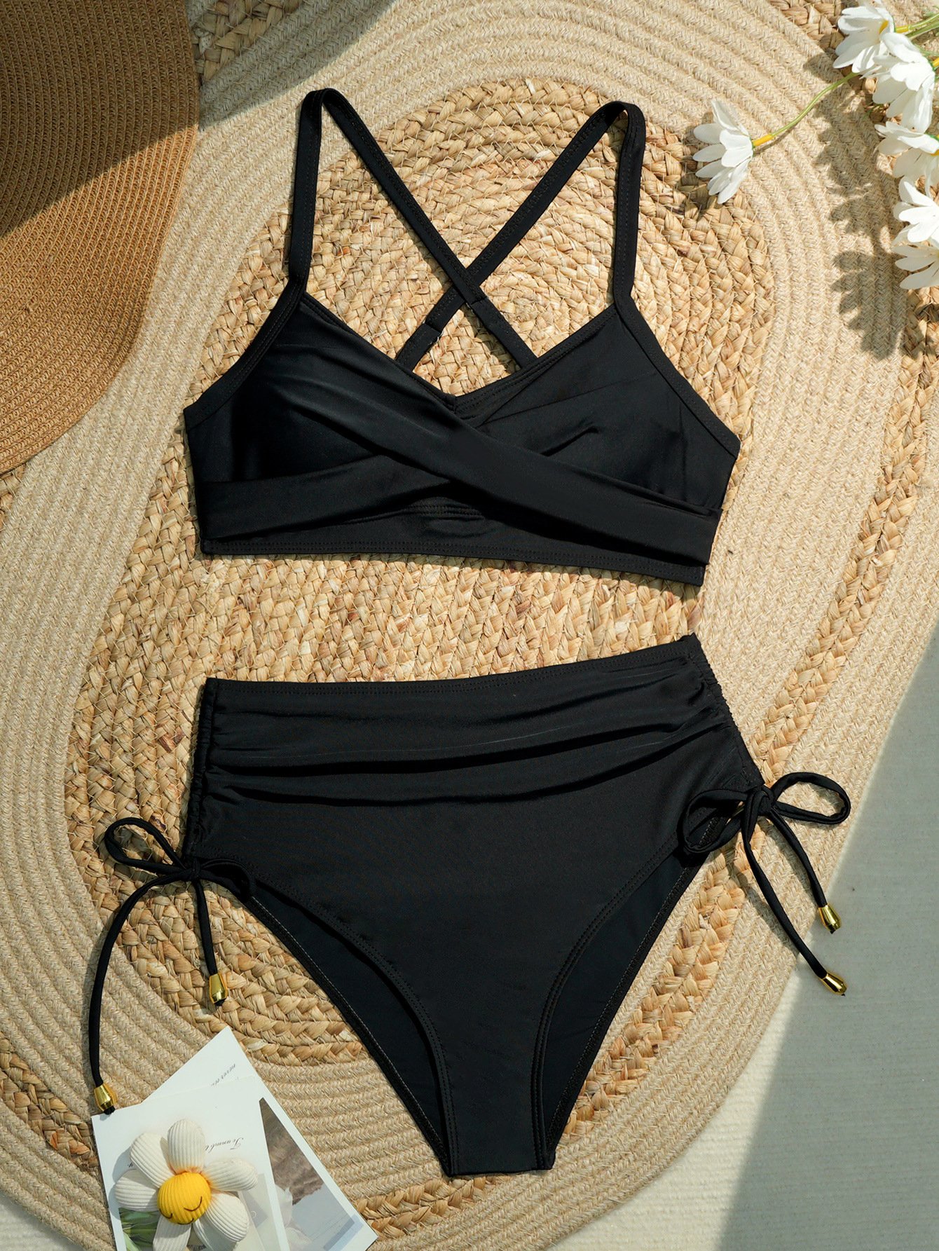 Black two-piece bikini set featuring a ruched halter crop top with crossback straps and high-waist tie-side bottoms.