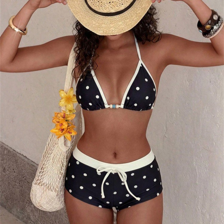 Black and white polka dot triangle halter bikini set with contrasting trim and boyshort bottoms.