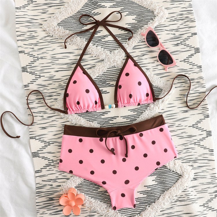 Pink polka dot bikini set with brown contrast trim, featuring a halter triangle top and boyshort bottoms.