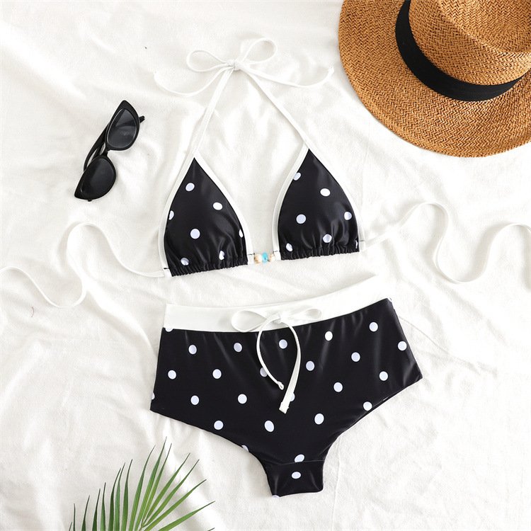 Black and white polka dot bikini set featuring a triangle halter top and high-waisted boyshort bottoms.