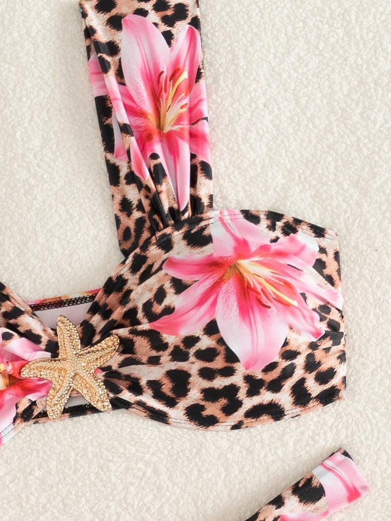 Close-up of a leopard and floral print bandeau bikini top with wide straps, a center twist knot, and