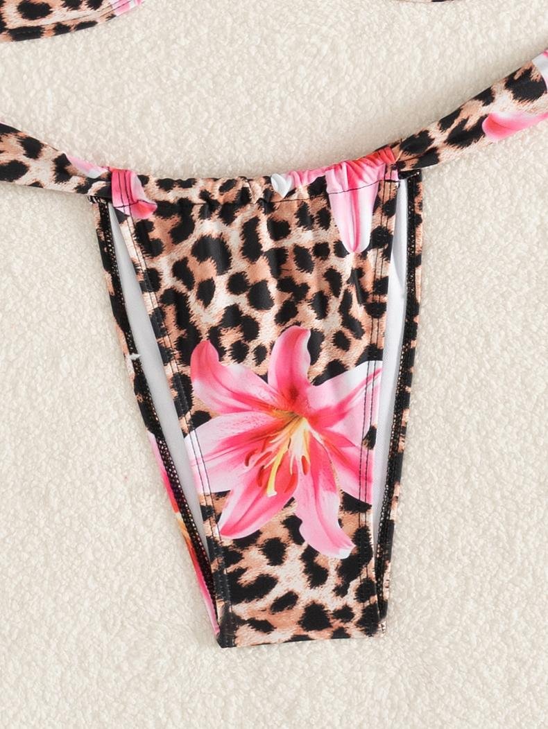 Leopard print bikini bottoms featuring a large pink lily flower design with side ties.